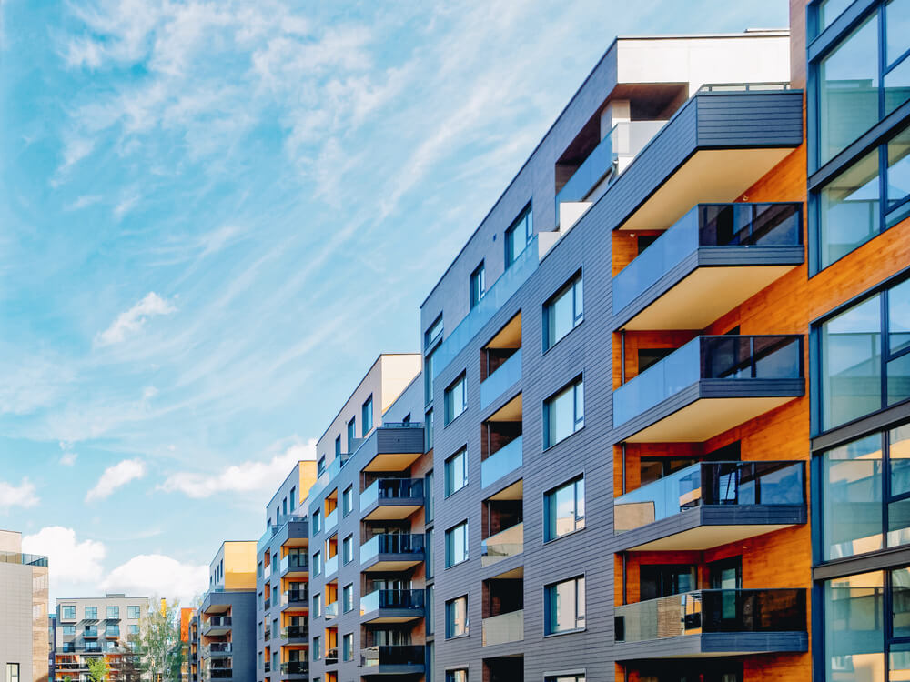Modern residential apartment and flat buildings exterior with outdoor facilities. New luxury house and home complex. City Real estate property and condo architecture. With background