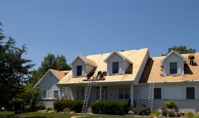 roofers replacing the roof